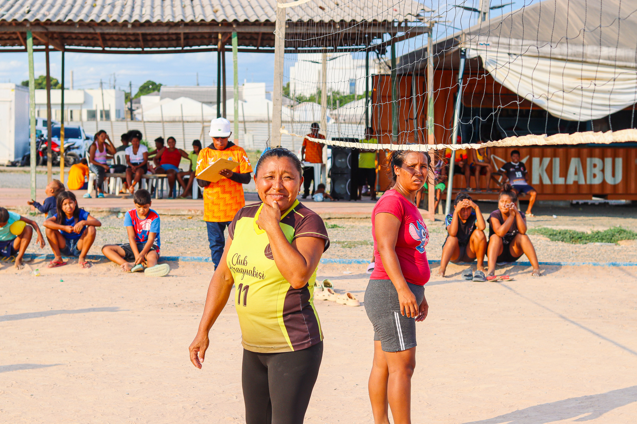 two community members posing during volleyball