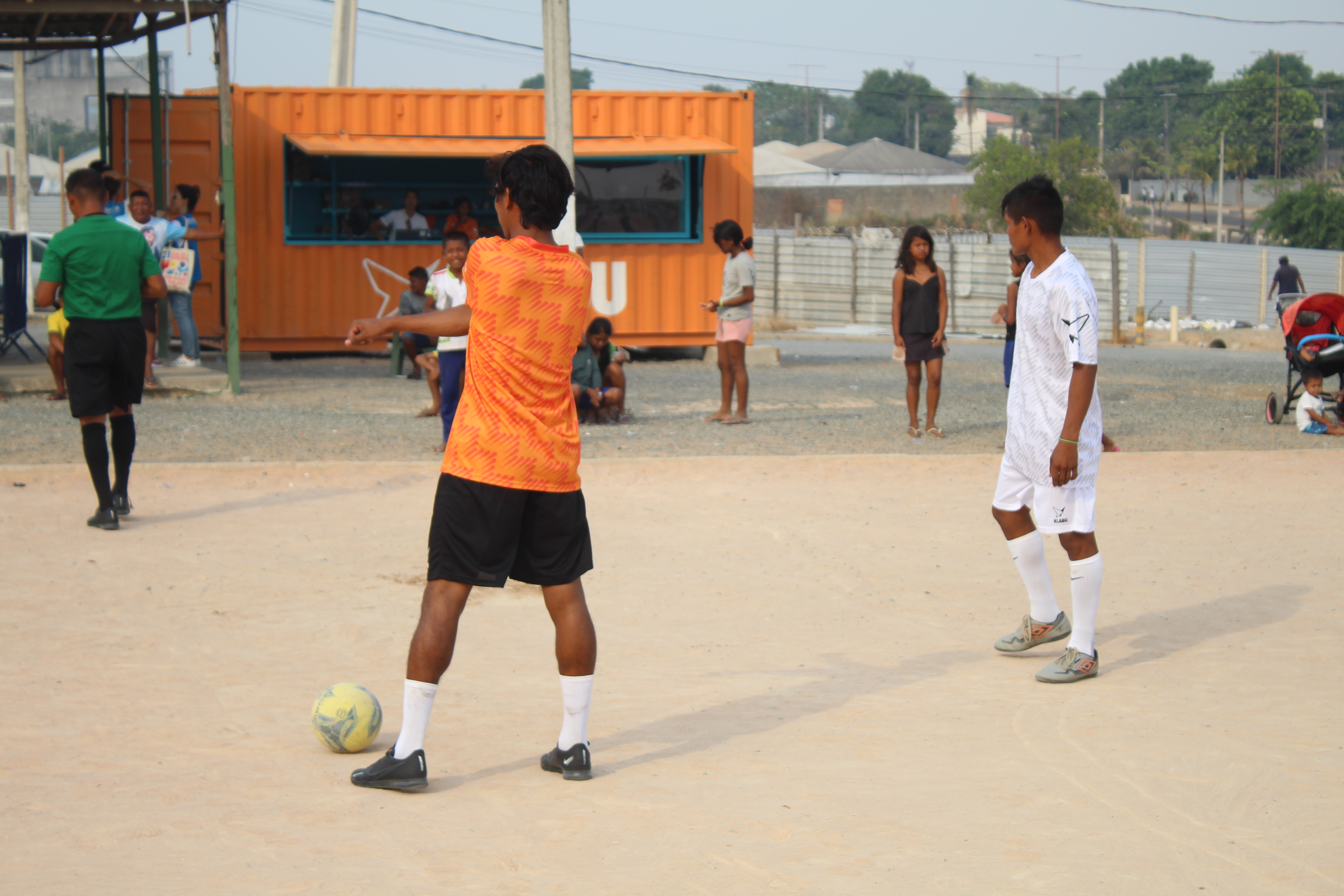 Football players with clubhouse in background