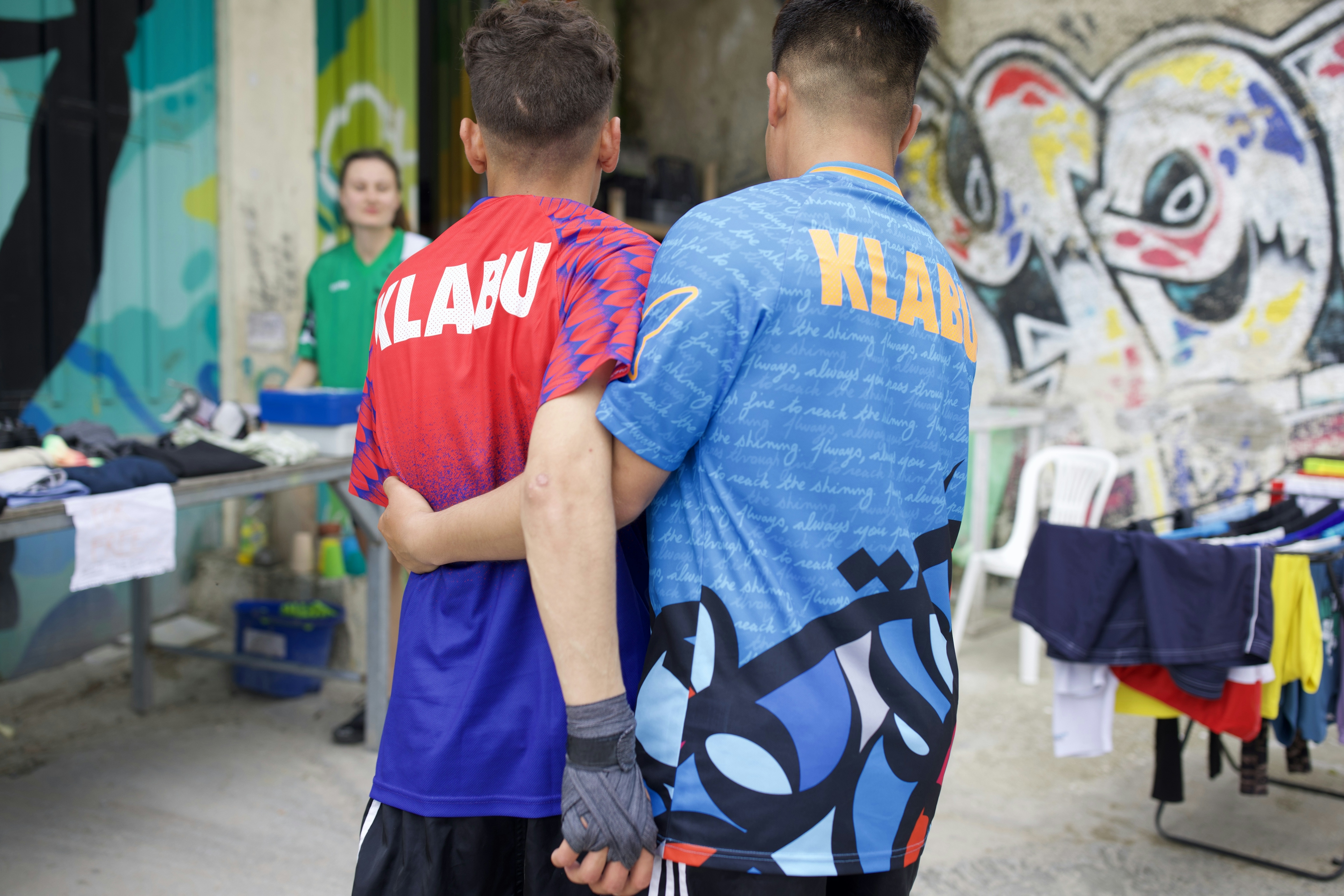 Two Refugees hugging at the Lesvos Klabu Clubhouse