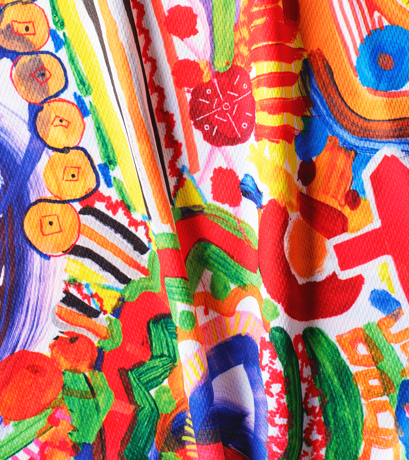 A vibrant, abstract T-shirt featuring a mix of colorful patterns, shapes, and symbols, with prominent reds, blues, yellows, and greens. Refugee sports sportswear impact