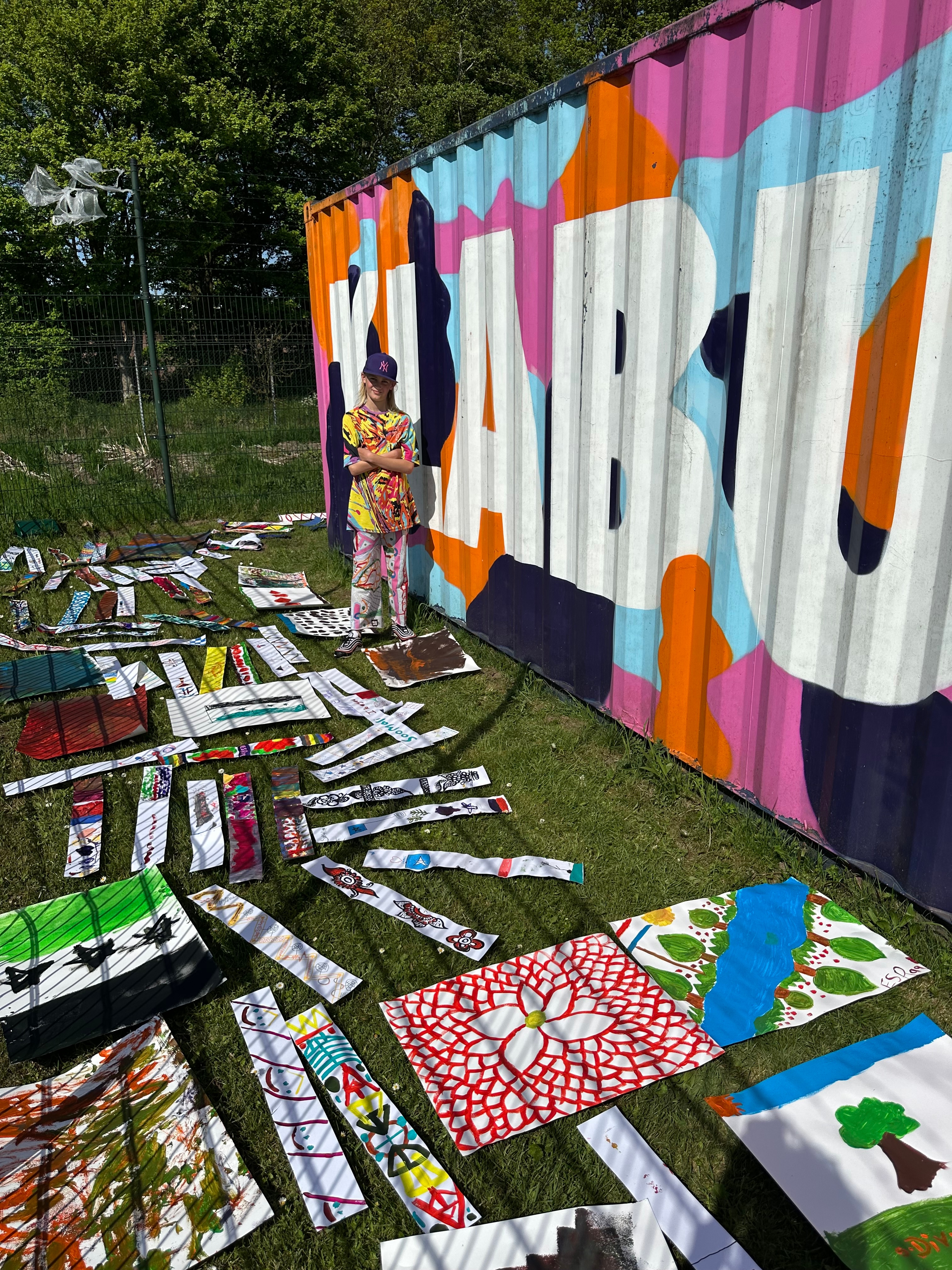 Alf stands proud with the art created by the kids in Ter Apel