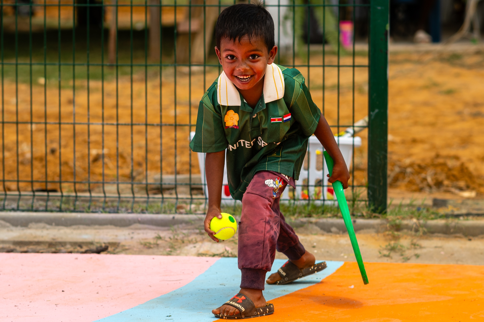 Small child playing with racket on court